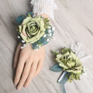 Artificial rose wrist flower and boutonniere set, elegant wedding floral detail.