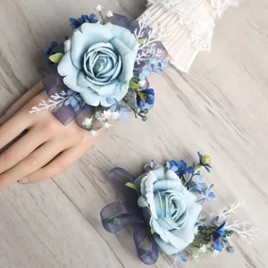 Artificial blue rose wrist flower and corsage set for wedding party and event decoration.