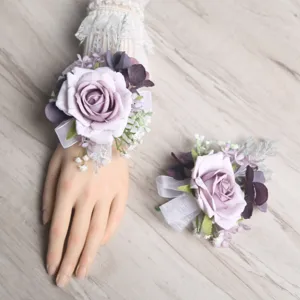 Close-up view of the elegant purple artificial rose wrist flower with delicate ribbons and leaves.