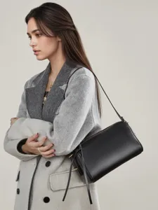 Black leather shoulder bag for women, stylish minimalist cylinder crossbody purse for daily wear.