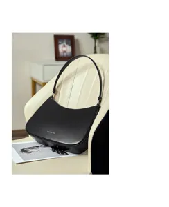 Detailed view of the sleek black leather underarm shoulder bag, showcasing premium texture.