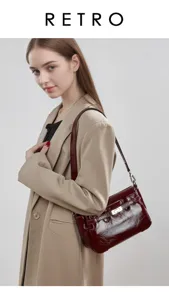 Detailed view of retro patent leather shoulder bag with metallic lock and chic strap design.