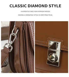 Close-up detail of brown leather vintage shoulder bag showing hardware and metal lock.