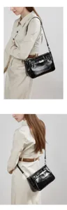 Sleek black patent leather shoulder bag detail, stylish women's crossbody for daily fashion.