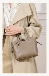 Detail view of a genuine leather taupe tote bag, featuring chic minimalist design for daily wear.