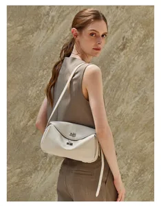 Chic genuine leather messenger bag with elegant metal turn-lock closure for casual daily style.
