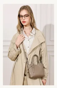 Detail shot of women's genuine leather bucket tote bag in taupe, chic casual crossbody style.