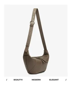 Bruine lederen halve maan tas detail, retro croissant schouder crossbody tas stijl.