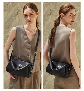 Detail view of the black leather crossbody messenger bag, featuring unique geometric panel design.