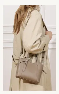 Niche design leather bucket tote bag detail showcasing the elegant taupe finish and straps.