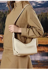 Detail view of a stylish minimalist beige leather hobo crossbody bag for women's daily commute.