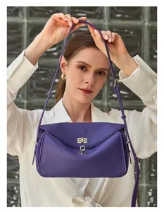 Chic purple leather crossbody shoulder bag featuring a secure metal turn-lock closure.