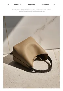 Elegante borsa a secchiello in vera pelle con manico intrecciato, design minimalista.