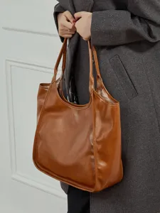 Bruine rundleer schoudertas met grote capaciteit, stijlvolle shopper tas voor dagelijks gebruik.