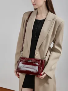 Minimalist elegant women crossbody shoulder bag with glossy patent leather and chic metal lock.