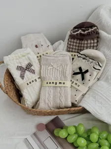 Sweet college style mid-tube socks with cute bows and polka dots for women daily wear.