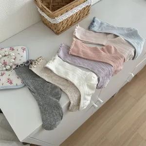 Detailed view of cute ruffly mid-calf mesh socks in multiple sweet soft solid colors.