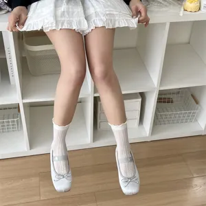 Close-up of sweet women's white ruffled hollow mesh JK socks paired with silver shoes.
