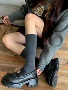 Detailed view of women wool blend ribbed calf socks, cozy winter long stacking socks styling.