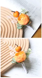 Close-up detail of autumn Halloween artificial rose and pumpkin brooch decoration.