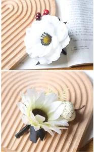 White artificial flower brooch detail view, Halloween festive corsage accessory with black ribbon.
