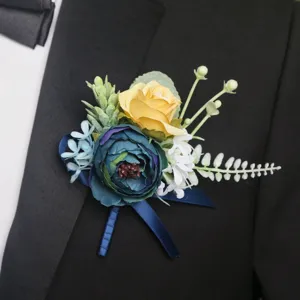 Wedding flower boutonnière detail shot, elegant fabric rose and leaves for groom suit accessory.