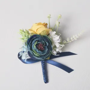 Detailed close-up of handmade artificial rose boutonniere with blue and yellow silk flowers.