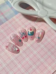 Cute pink press-on nail art detail with 3D cherry pudding bow lace design for summer.