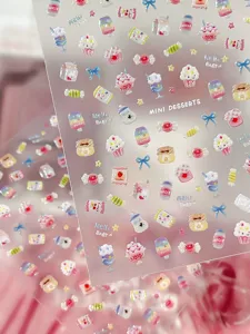 Detailed close-up of cute 3d dessert and candy nail art stickers with clear transparent backing.