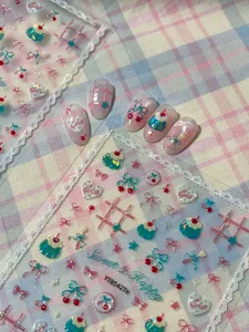 Detailed view of sweet cherry and dessert nail art stickers with cute bows and lace borders.
