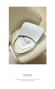 Minimalist white genuine leather underarm bag, chic crescent design for women's daily fashion.