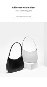 Detailed view of minimalist genuine leather underarm shoulder bag with delicate fan side buckles.