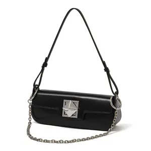 Zwarte lederen schoudertas voor dames met chique metalen piramidesluiting en ketting.