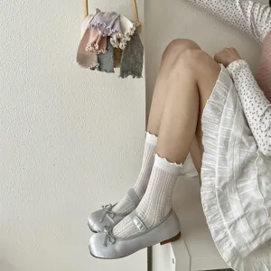 Summer sweet women ruffle mesh mid tube socks with elegant silver flat shoes on model.