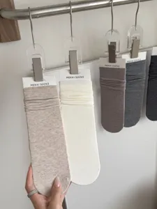 Minimalist solid color cotton slouch socks detail, soft and comfortable daily wear accessory.