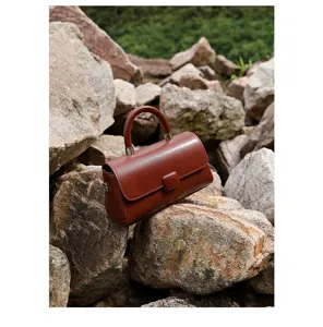 Detail view of a stylish brown genuine leather handbag, perfect for lightweight daily wear.