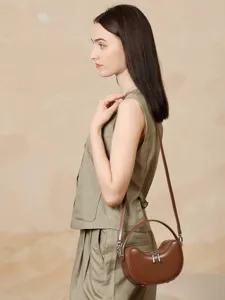 Elegant genuine leather crossbody dumpling bag for women, chic curved design, stylish summer purse.