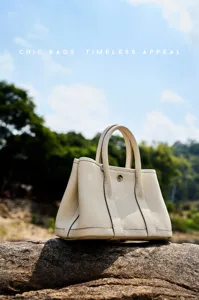 Detailed close-up view of the premium leather tote bag outdoors, featuring exquisite pebble texture.