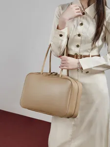 Elegant beige leather Boston handbag for women, stylish top handle shoulder bag for daily wear.