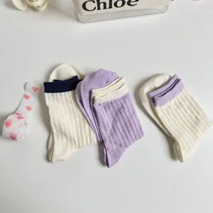 Detailed view of cute womens mid calf ribbed socks in multiple stylish color combinations.