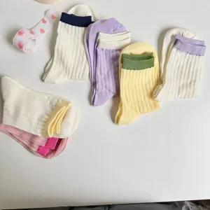 Detailed view of colorful cuff ribbed mid-tube cotton socks for women, comfortable daily wear.