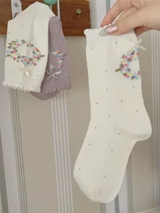 Korean style sweet mid-calf socks detail showing floral wreath embroidery and cute bows.