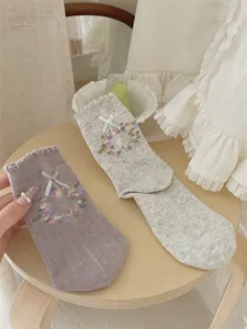 Sweet floral bow mid-tube socks detail, cute lace mesh design, cozy daily lifestyle style.