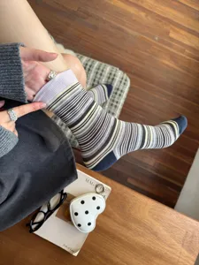 Detailed view of retro striped mid-tube socks, featuring stylish color blocking and cozy knit fabric.