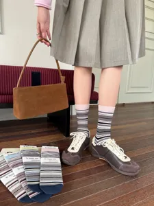 Detail shot of retro striped mid-tube socks featuring color blocking and soft cotton knit.