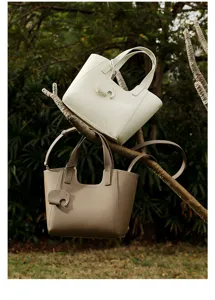 Casual large capacity leather tote bag for women, stylish daily commuting handbag with charm.
