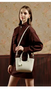 White leather tote bag with top handles and shoulder strap, detailed daily casual handbag.