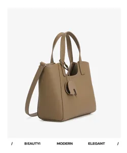 Stylish minimalist leather tote bag for women, spacious daily commuter shoulder bag with charm.
