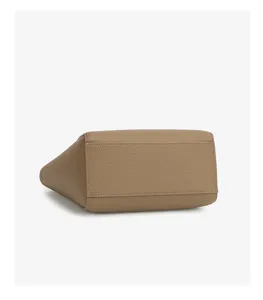 Detail view of casual large capacity leather tote bag bottom, premium stitching and texture.