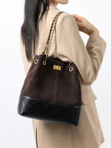 Elegante borsa a spalla in camoscio marrone e pelle nera con catena dorata e chiusura.